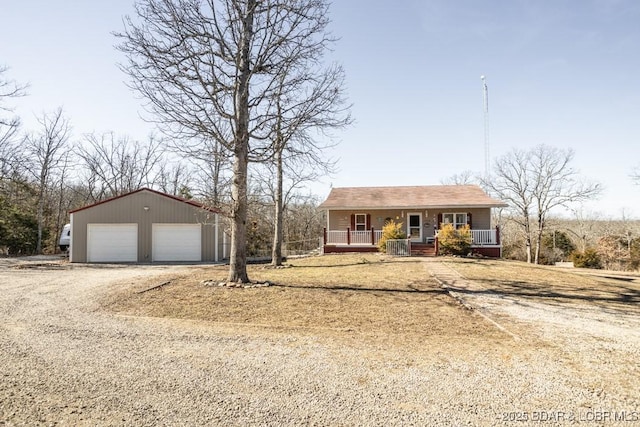 single story home with a garage, an outdoor structure, and covered porch