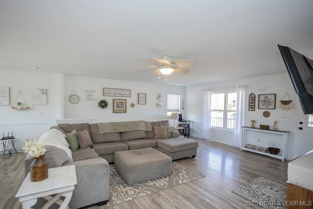 living room with wood-type flooring and ceiling fan