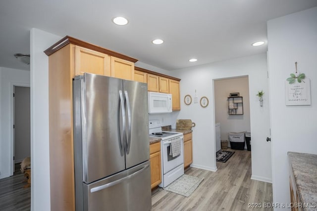 kitchen featuring light wood-type flooring, light brown cabinetry, and white appliances