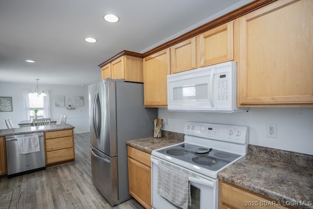 kitchen with decorative light fixtures, a chandelier, light brown cabinets, appliances with stainless steel finishes, and light hardwood / wood-style floors