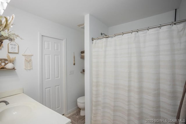 bathroom with vanity and toilet