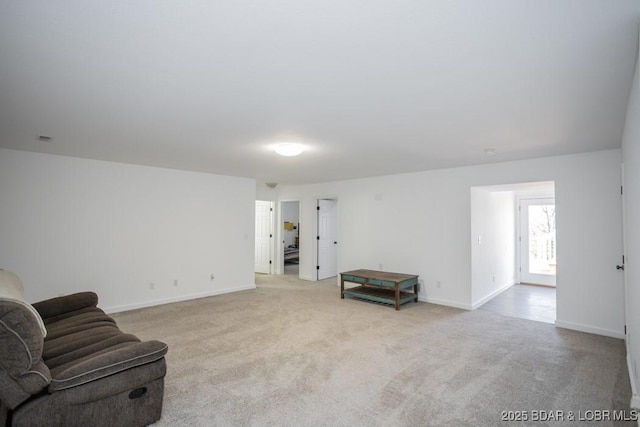 living area featuring light carpet