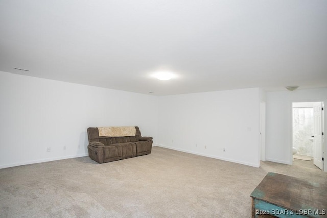 living area featuring light colored carpet