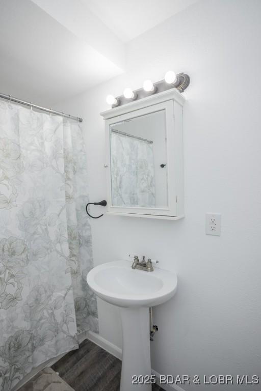 bathroom with hardwood / wood-style floors and sink