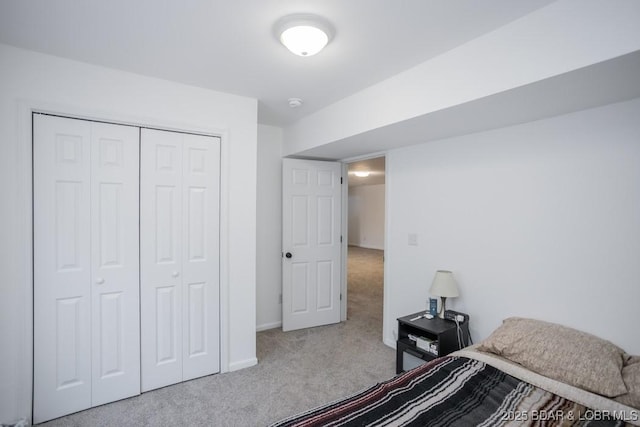 bedroom featuring a closet and light carpet