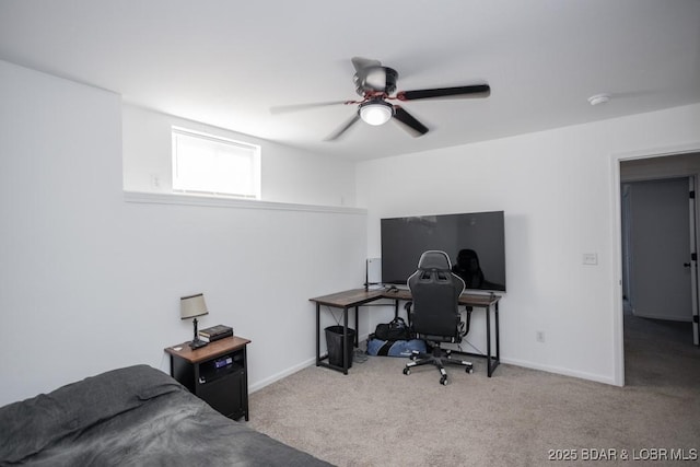 carpeted office space featuring ceiling fan