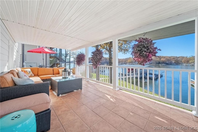 view of patio / terrace with a water view, a balcony, and an outdoor hangout area