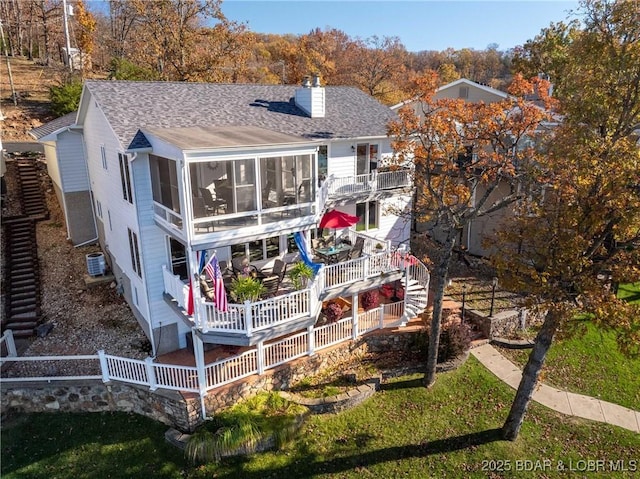 back of house with a sunroom and a deck