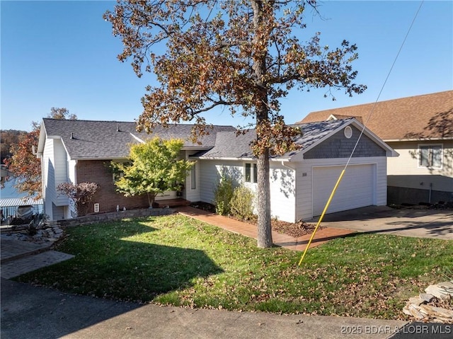 back of house featuring a garage and a yard