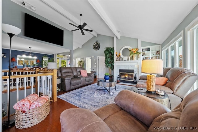 living room featuring a tile fireplace, ceiling fan, beam ceiling, high vaulted ceiling, and dark hardwood / wood-style floors