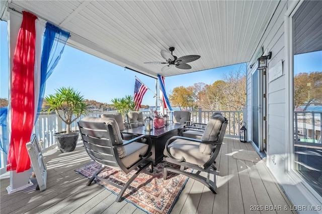 wooden terrace featuring ceiling fan