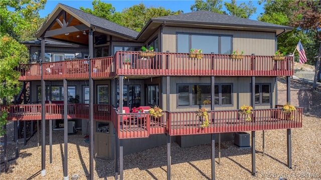 6 Cardinal Cir, Lake Ozark, MO 65049 - back of property featuring cooling unit, a shingled roof, a balcony, and a deck