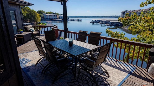 wooden terrace featuring a water view