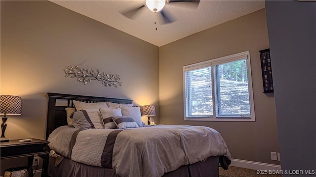 bedroom with ceiling fan, carpet flooring, and vaulted ceiling