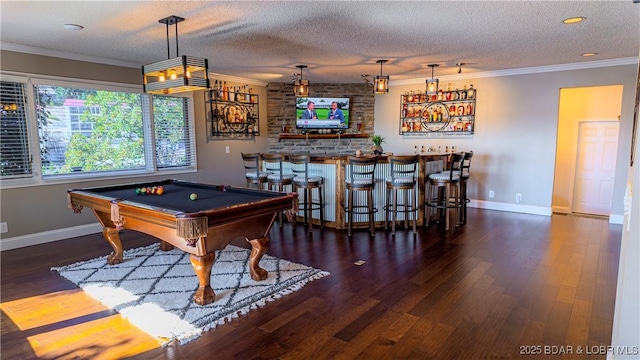 game room with ornamental molding, dark hardwood / wood-style floors, and a textured ceiling