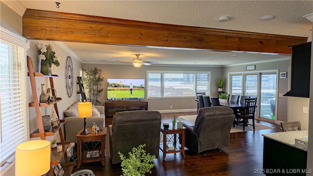 living room featuring dark hardwood / wood-style flooring, ceiling fan, crown molding, a textured ceiling, and beam ceiling