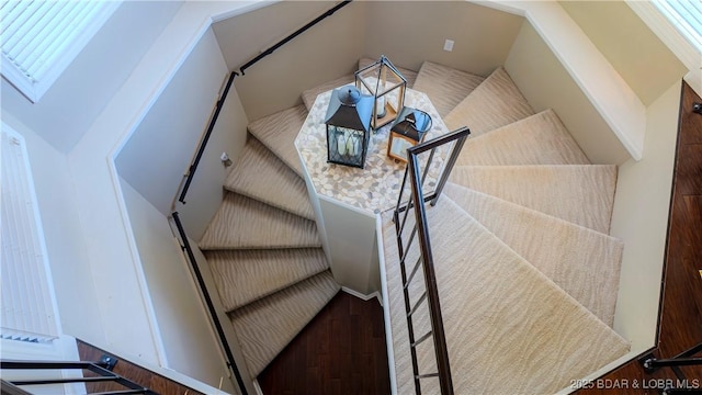 stairs featuring hardwood / wood-style floors