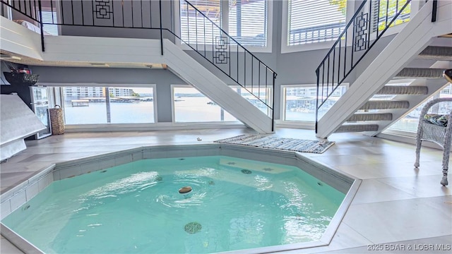 view of swimming pool with an indoor hot tub