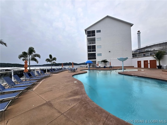 view of swimming pool with a patio