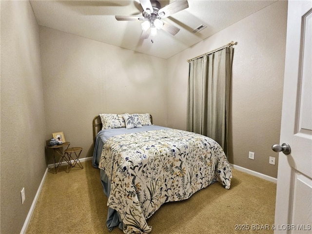 bedroom with light carpet and ceiling fan