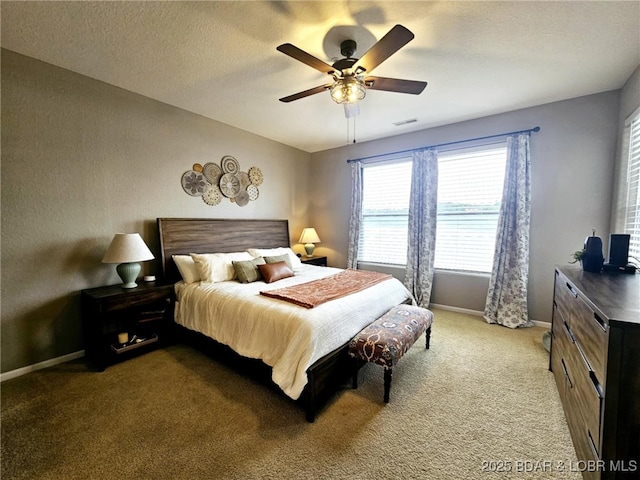 bedroom featuring a ceiling fan, baseboards, light colored carpet, and visible vents