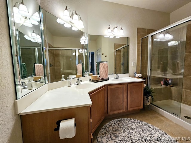 bathroom with vanity, a shower with shower door, and tile patterned floors