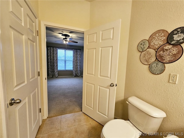 bathroom with ceiling fan, tile patterned floors, and toilet