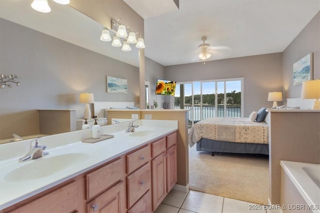 bathroom featuring a tub to relax in, ceiling fan, vanity, and tile patterned flooring