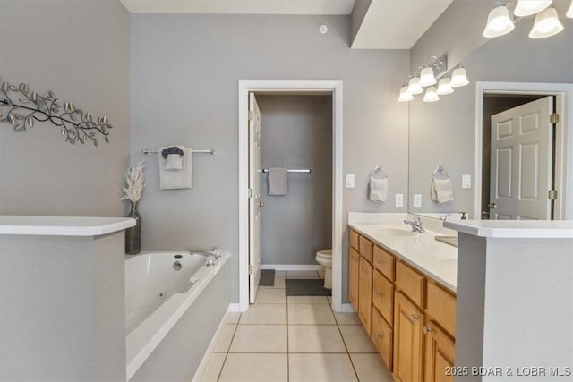 bathroom featuring vanity, a tub to relax in, tile patterned floors, and toilet