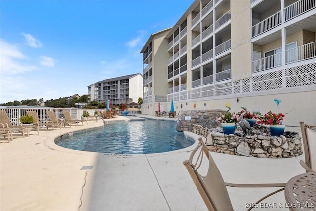 view of pool featuring a patio