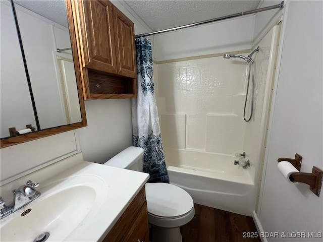 full bathroom with toilet, wood-type flooring, a textured ceiling, vanity, and shower / bath combo