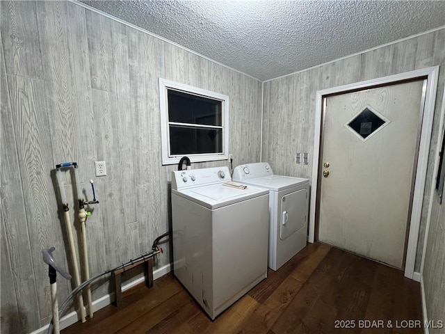 laundry room with separate washer and dryer, dark hardwood / wood-style flooring, and a textured ceiling