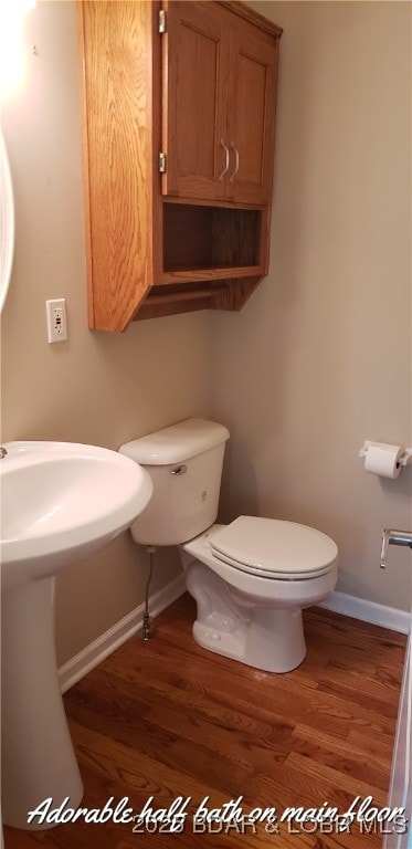 bathroom featuring toilet and hardwood / wood-style floors