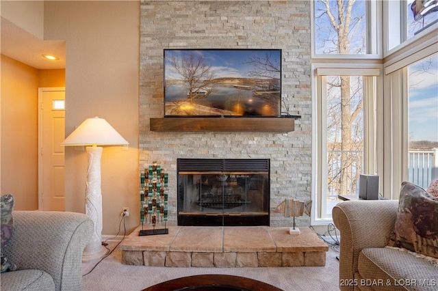 living room with carpet floors and a fireplace