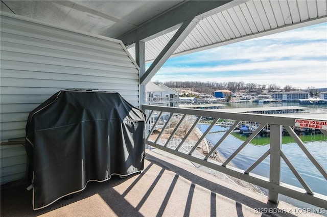 balcony with area for grilling and a water view