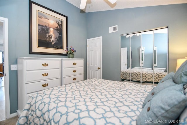 bedroom featuring lofted ceiling, a closet, and ceiling fan