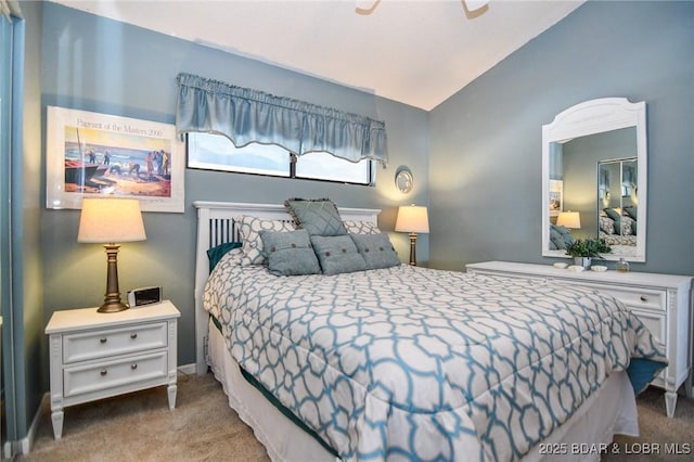 bedroom with ceiling fan, vaulted ceiling, and carpet