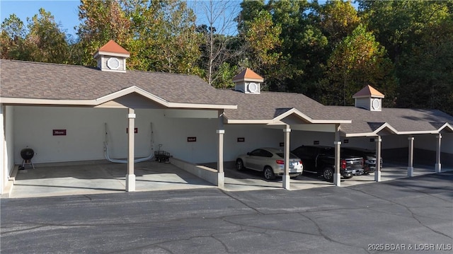 view of parking / parking lot featuring a carport