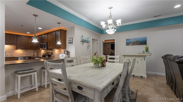 tiled dining room with ornamental molding and an inviting chandelier