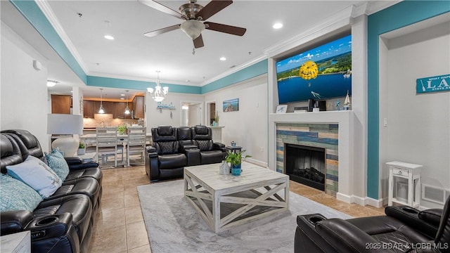 tiled living room with crown molding, ceiling fan with notable chandelier, and a fireplace