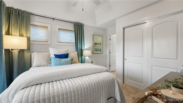 carpeted bedroom featuring a closet and ceiling fan