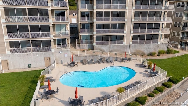 view of swimming pool featuring a lawn and a patio area