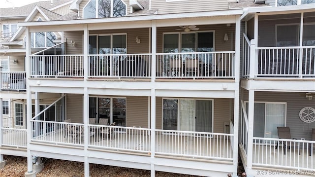 rear view of property featuring ceiling fan