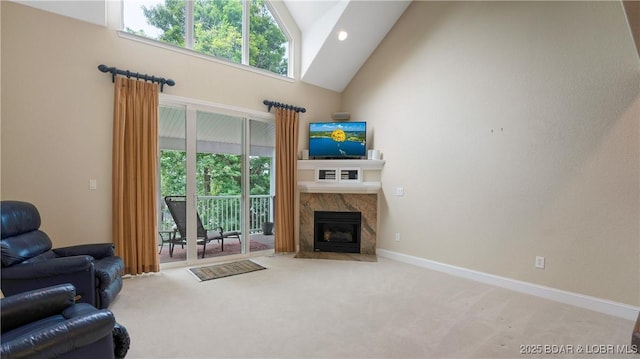 living room with high vaulted ceiling, a high end fireplace, and carpet floors