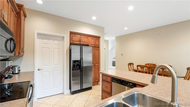 kitchen with stainless steel appliances and light tile patterned flooring