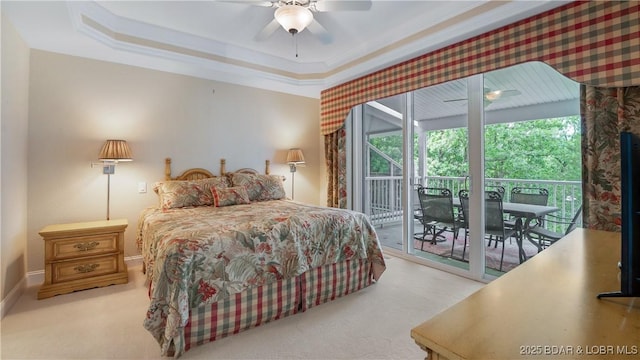 bedroom with access to outside, ornamental molding, and a raised ceiling