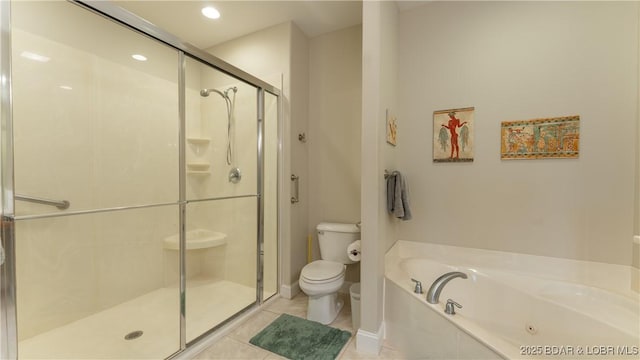 bathroom with tile patterned floors, toilet, and separate shower and tub