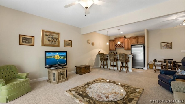 living room with light carpet, beam ceiling, and ceiling fan