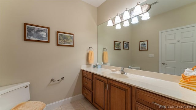 bathroom with vanity, tile patterned floors, and toilet