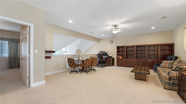 office space featuring light carpet and ceiling fan